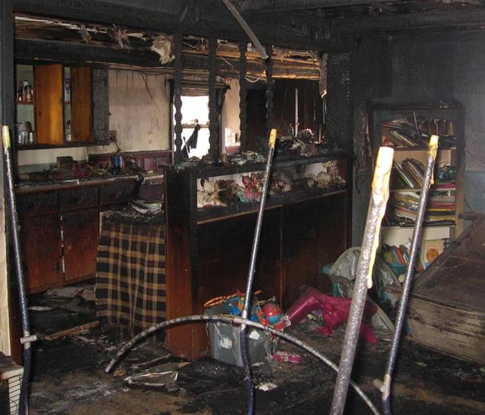 Kitchen cabinets, structural framing and finishes are charred.